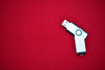 USB flash drive on a red velvet background
