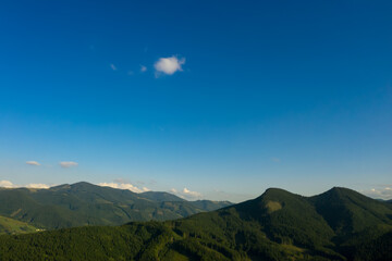 Fototapeta premium Aerial view of beautiful mountain landscape with forest on sunny day. Drone photography