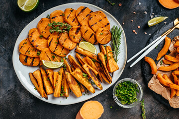 Homemade Baked orange sweet potato fries with lime and herbs, Food recipe background. Close up, top view