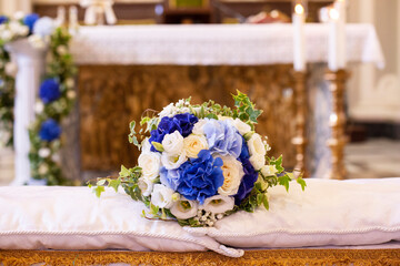 Wedding bouquet over the grooms bench