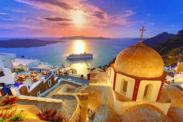 Santorini island, Greece. Traditional and famous houses and churches with blue domes over the...