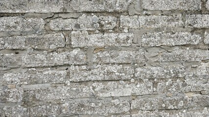 Detail view of wall structure made of grey bricks.
