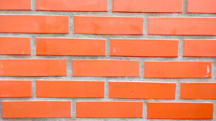 Detail of wall made of classical red bricks. The brick are very ordered and well built.