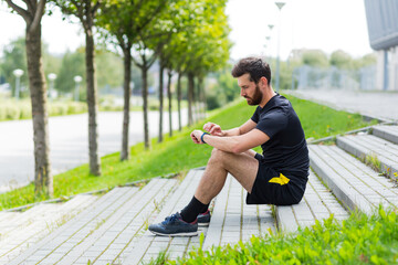 Sport Caucasian man looking smart watch at modern track runner using use smartwatch fitness bracelet Portrait fit male athlete checking result jogging in sportswear in street urban city park outdoor - Powered by Adobe