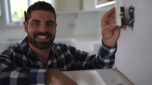 Portrait of an electrician happy worker at work