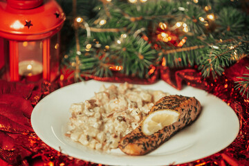Traditional christmas food, salmon with potato salad on the table, food concept