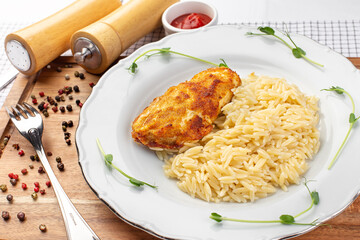 chicken fillet with white rice on the wooden background