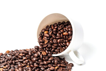 Coffee beans are scattered from a coffee cup on a white background.