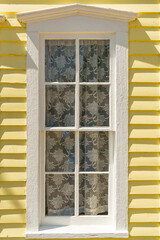 Old White Wooden Window on a yellow house