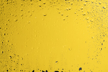 Yellow backgrond with water drops.