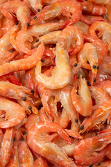 Shrimps background texture. A lot of shrimps. Cooked shrimps.