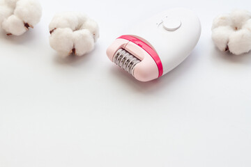 Epilator with cotton flowers. Hair removal and depilatory concept