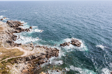 The rocky coast of France over the Atlantic Ocean, viewed from the drone. A beautiful sea landscape.