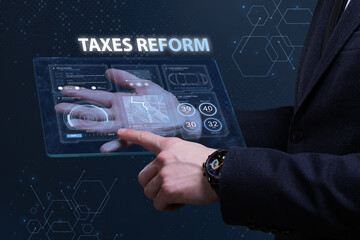 Business, Technology, Internet and network concept. Financial Graph. Stock Market chart. Young businessman working on a virtual screen of the future and sees the inscription: Taxes reform