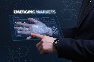 Business, Technology, Internet and network concept. Financial Graph. Stock Market chart. Young businessman working on a virtual screen of the future and sees the inscription: Emerging markets