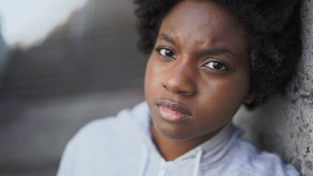 Portrait of a thoughtful black mixed race african female on concreate place