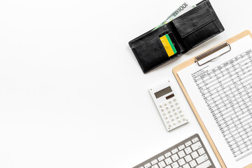 Calculating bills or taxes reports with with purse and bank cards, top view