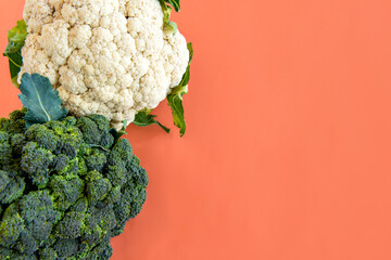 Broccoli and cauliflower on orange background.