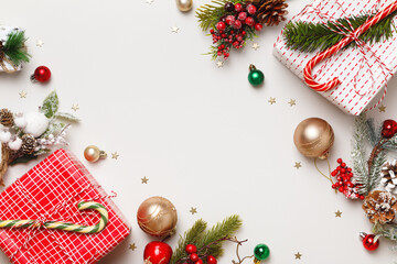 New Year's winter composition. Christmas boxes with balls of fir branches of gifts on a gray background. Frame border flat lay top view copy space