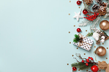 New Year's composition. Christmas boxes with gift fir branches on a blue background. Frame border flat lay top view copy space