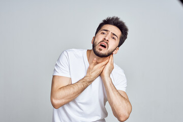 bearded man in white t-shirt posing gesturing with his hands