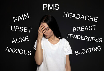 Hormones imbalance. Upset young woman and different words on black background