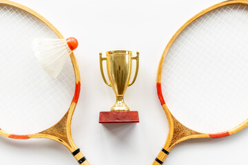 Badminton winner award - small golden trophy cup with rackets and shuttlecock