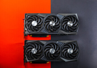 Gaming video cards on a red and black background for video games and cryptocurrency mining. Computer part. GPU card. copy space