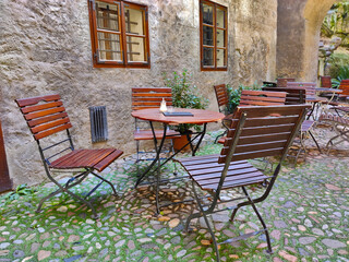 Outdoor seats of a cafe located in one of the courtyards of the Cesky Krumlov castle.