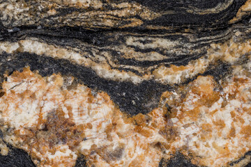 Multicolored crystalline texture of polished granite slab. Granite rock made of coarse-grained interlocking crystals