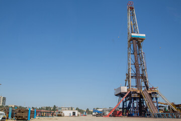 Land oil drilling rig blue sky .Land rig during the drilling operation . Oil and gas drilling rig...