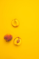 Flat lay composition with fresh peaches on yellow background. Flat lay top view copy space.