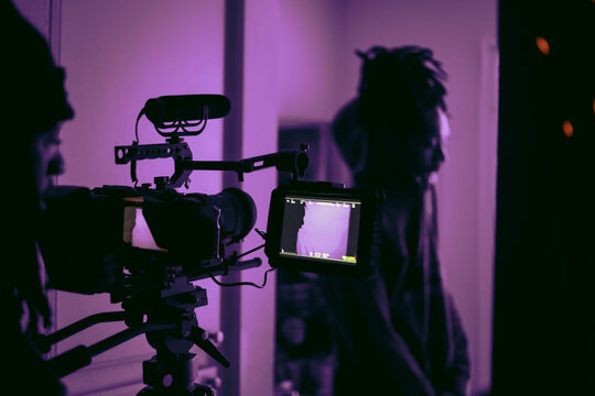 Black camera with tripod in grayscale