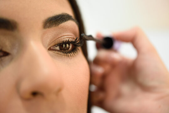 Close-up shot of woman wearing mascara