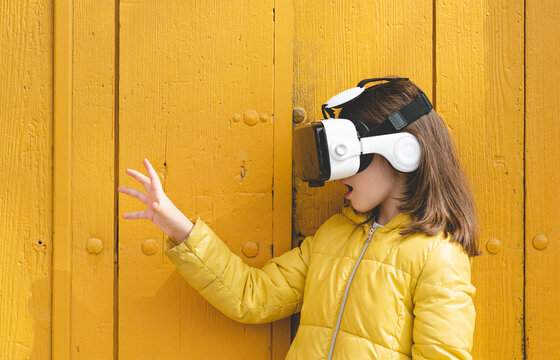 Girl in yellow jacket wearing VR headset