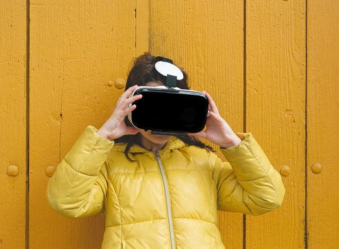 Girl in yellow jacket with VR headset