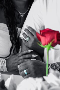 Grayscale photo of bride and groom and groom linking arms
