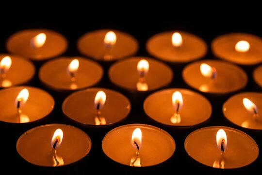 Lit candles in dark background