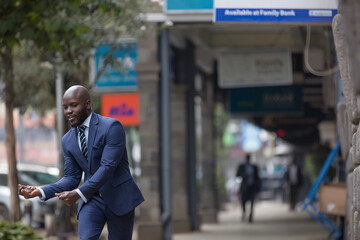 Man in blue suit walking on sidewalk