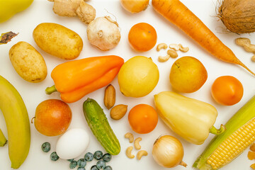 Various healthy fresh vegetables, fruits and nuts on a white background. Balanced diet food