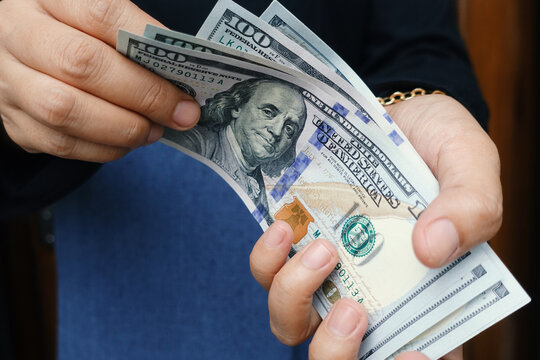 Person counting dollars