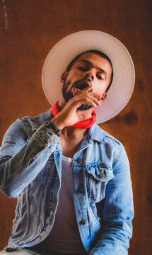 Portrait of seductive man wearing straw hat