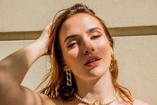 Portrait of young woman wearing golden earrings