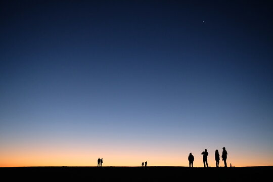 Silhouette of people standing outdoor during sunset