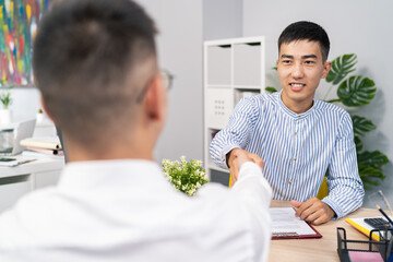Two men meet in company office morning for interview disabled boy arrives in wheelchair wearing...