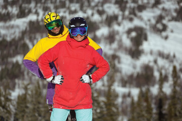 Couple of snowboarders posing at ski resort