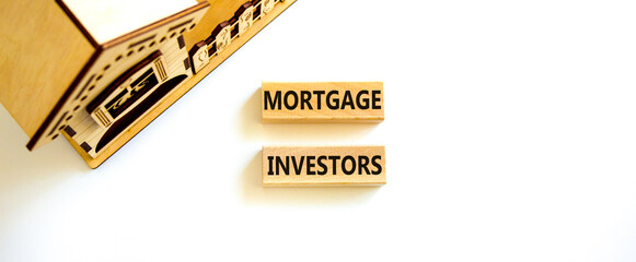 Mortgage investors symbol. Concept words 'Mortgage investors' on wooden blocks near miniature wooden house. Beautiful white background. Business, mortgage investors concept.