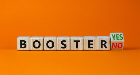 Covid-19 booster vaccine shot yes or no symbol. Turned a wooden cube and changed words booster no to booster yes. Beautiful orange background, copy space. Covid-19 booster vaccine shot concept.