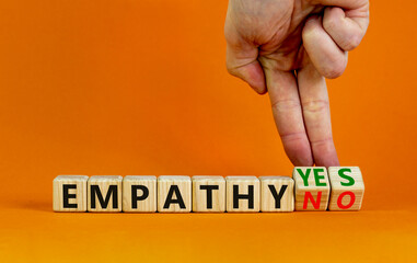 Empathy yes or no symbol. Psychologist turns wooden cubes and changes words empathy no to empathy...