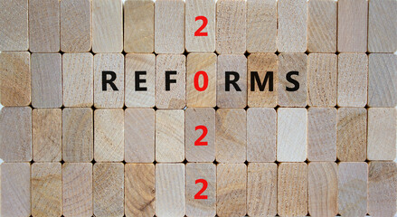 2022 reforms new year symbol. Wooden blocks with words 'Reforms 2022'. Beautiful wooden background, copy space. Business, 2022 reforms new year concept.